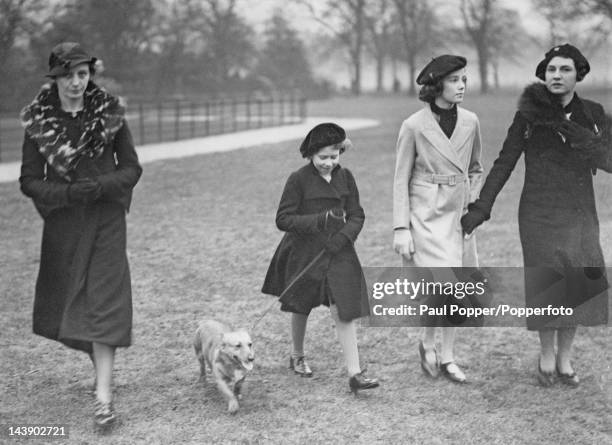 Princess Elizabeth walking her dog in Hyde Park, London, 26th February 1936. She is accompanied by her governess, Marion Crawford .