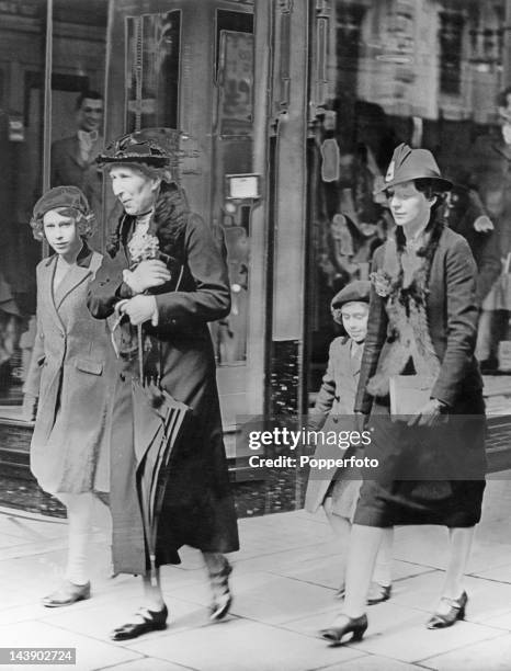 Royal governess Marion Crawford accompanies Princesses Elizabeth and Margaret to a London Underground station, on their way to visit the headquarters...