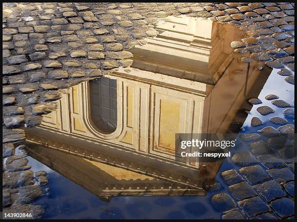 piece of history in puddle - cobblestone puddle stock pictures, royalty-free photos & images