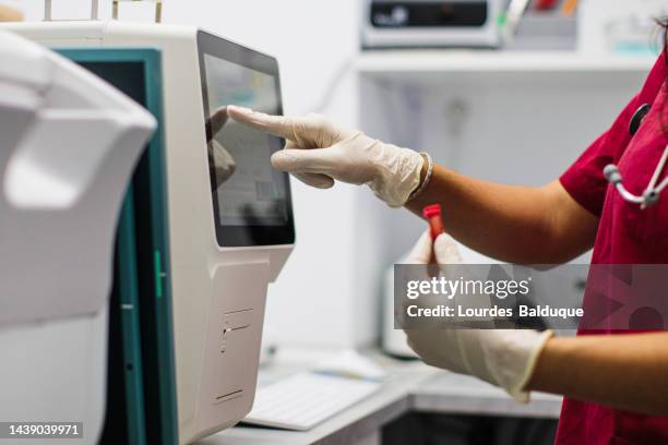 technician woman with test tube in laboratory, blood analysis - hematology stock pictures, royalty-free photos & images