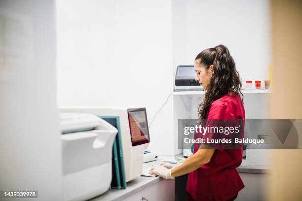 technician woman with test tube in laboratory, blood analysis - südeuropa stock-fotos und bilder