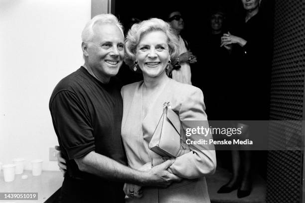 Actress Lauren Bacall and designer Giorgio Armani pose for photos backstage after the fashion show.