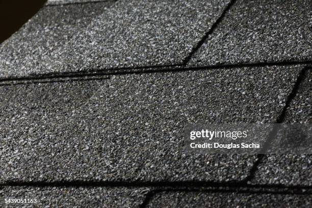 closeup of a slanted roof with asphalt 3 tab shingles - roof replacement stock pictures, royalty-free photos & images