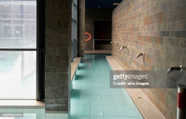 corridor with water jets in a luxury pool in a spa with bay windows - balneario fotografías e imágenes de stock