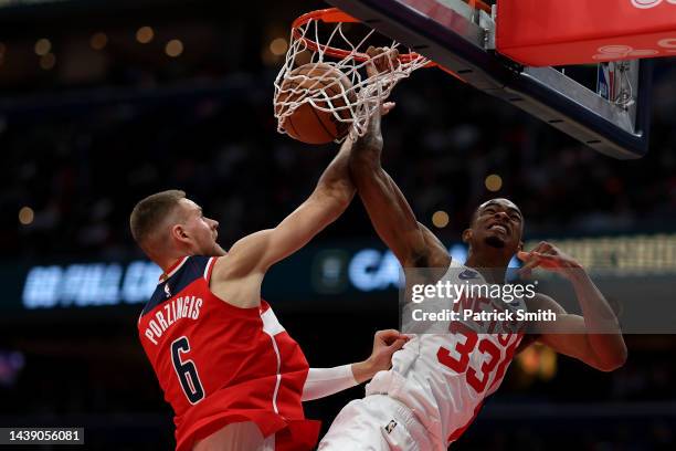 Nic Claxton of the Brooklyn Nets dunks on Kristaps Porzingis of the Washington Wizards dat Capital One Arena on November 4, 2022 in Washington, DC....