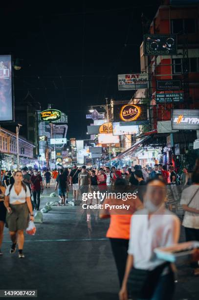 crowds and businesses in the famous khao san road, bangkok, thailand - khao san road stock pictures, royalty-free photos & images