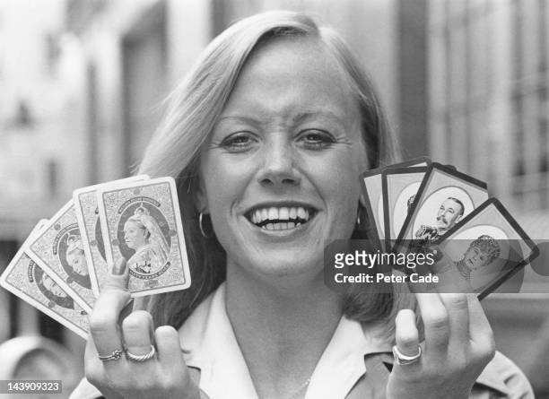 Playing card researcher and designer Avril Walsh , of the Waddington's game company, holding playing cards commemorating the Diamond Jubilee of Queen...