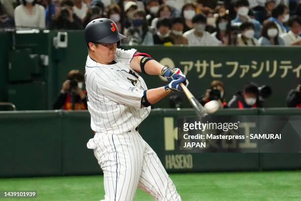 Infielder Shugo Maki of Samurai Japan hits a solo home run in the first inning during the game between Samurai Japan and Hokkaido Nippon-Ham Fighters...