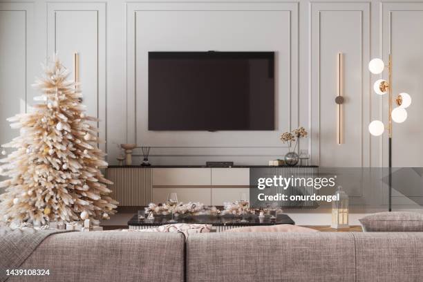 modern living room interior with christmas tree, ornaments, gift boxes, sofa and lcd tv set - lcd television stockfoto's en -beelden