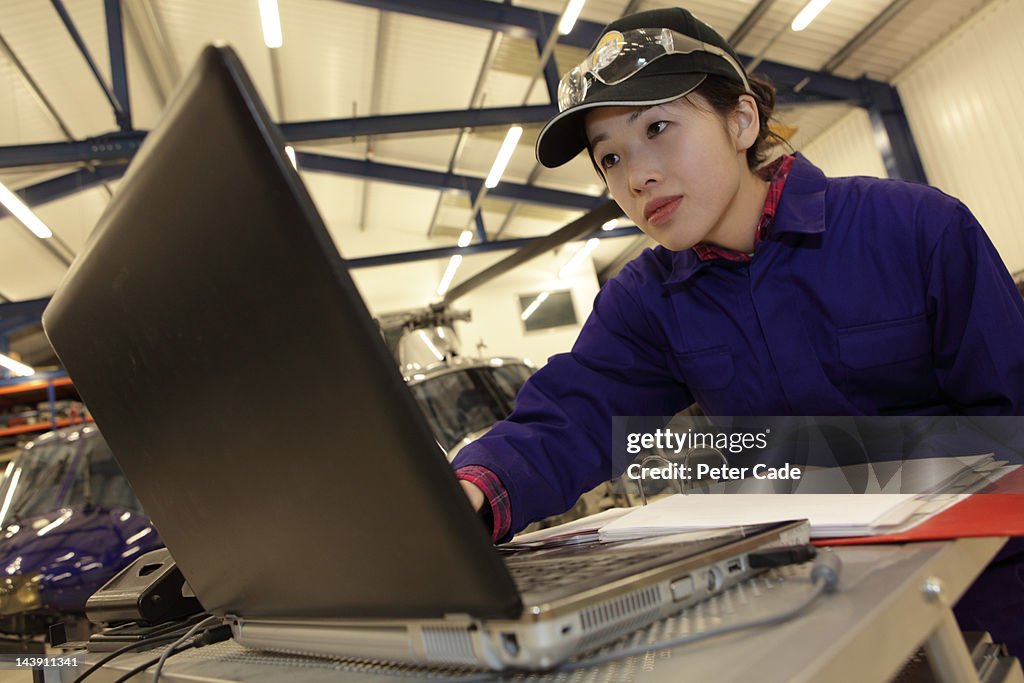 Female engineer looking at laptop