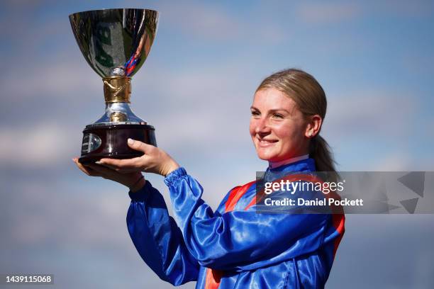 Jamie Kah poses for a photograph with the trophy after riding Zaaki to win race 8 the TAB Champions Stakes during 2022 TAB Champions Stakes Day at...