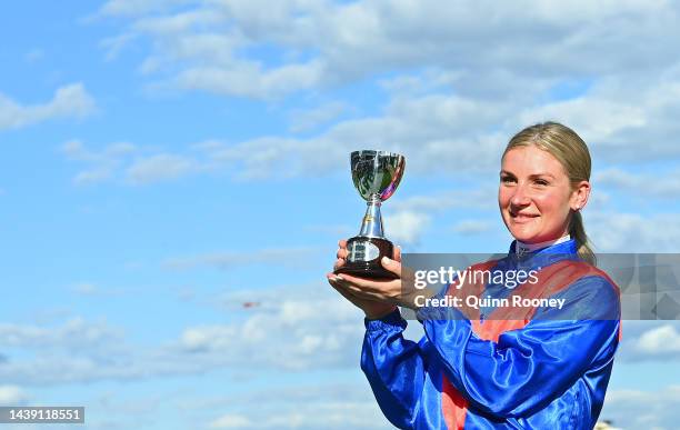 Jamie Kah poses with the champions trophy after riding Zaaki to win Race 8, the Tab Champions Stakes, during 2022 TAB Champions Stakes Day at...