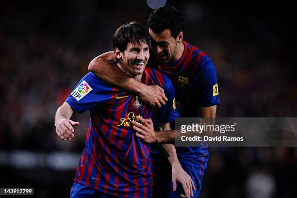 Lionel Messi of FC Barcelona celebrates with his teammate Sergio Busquets of FC Barcelona after scoring the opening goal during the La Liga match...