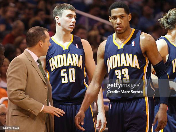 Forward Danny Granger and Tyler Hansbrough of the Indiana Pacers chat with coach Frank Vogel during a game against the Orlando Magic in Game four of...