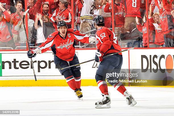 Alex Ovechkin and Mike Green of the Washington Capitals celebrate their third goal during the third period of Game Four of the Eastern Conference...