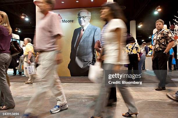 Shareholders walk past an image of Warren Buffett, chairman of Berkshire Hathaway Inc., during the Berkshire Hathaway annual shareholders meeting in...