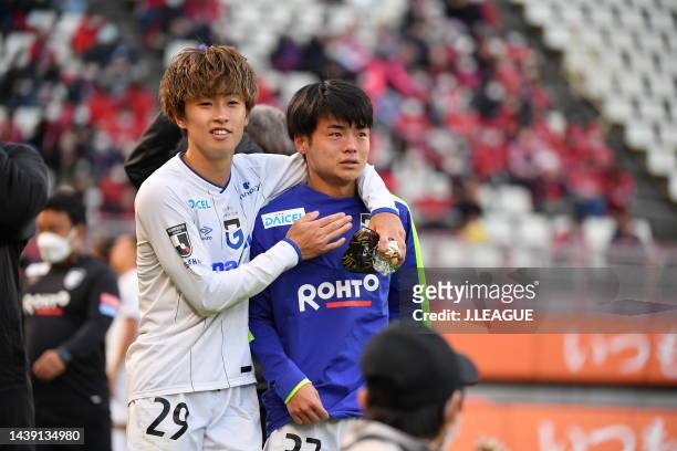 Yuki YAMAMOTO of Gamba Osaka and Hiroto YAMAMI of Gamba Osaka celebrate as they avoid the relegation to the J2 after the 0-0 draw in after the...