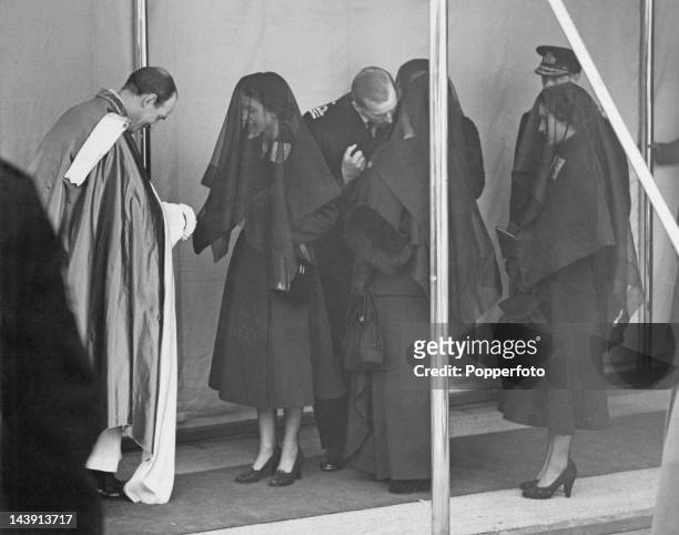 Queen Elizabeth II shakes hands with Eric Hamilton, Dean of Windsor at the funeral of her father King George VI at St George's Chapel, Windsor, 15th...