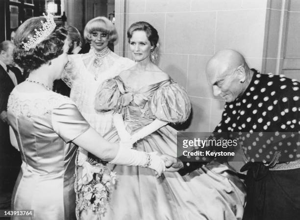 Queen Elizabeth II shakes hands with actor Yul Brynner after the Royal Variety Performance at the Theatre Royal Drury Lane, London, 27th December...