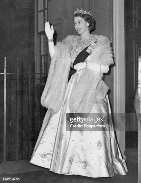 Queen Elizabeth II leaving the Royal Archers Hall, Edinburgh, after a ball given by the Royal Company of Archers, 28th June 1952. The function is the...