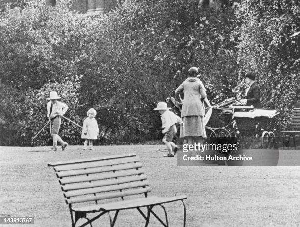 Princess Elizabeth playing with her cousins George and Gerald Lascelles, circa 1929.