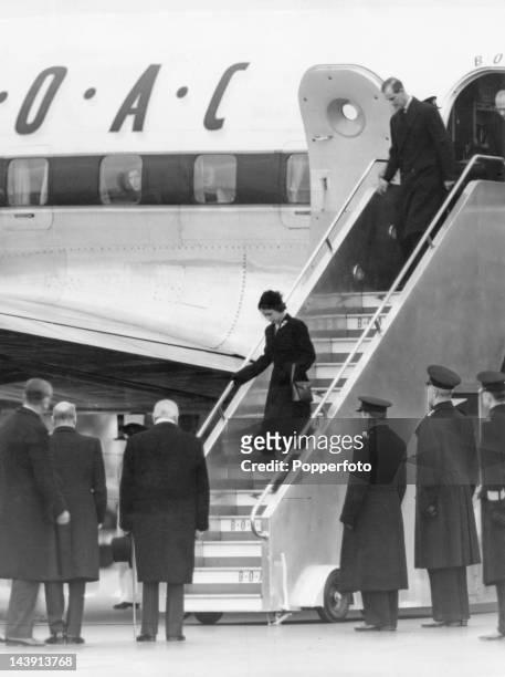 Queen Elizabeth II steps from her plane on her at arrival at London Airport after being recalled from Kenya following the death of her father King...