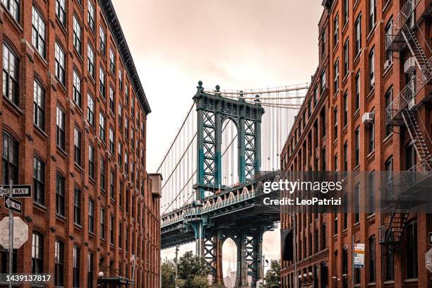 dumbo view to manhattan bridge in new york city - manhattan bridge stock pictures, royalty-free photos & images