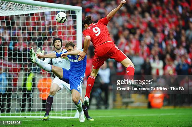 Andy Carroll of Liverpool heads the ball and Petr Cech of Chelsea pushes it onto the cross bar during the FA Cup Final with Budweiser between...