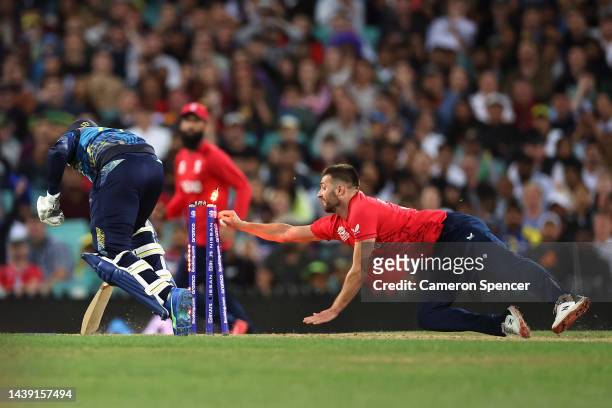 Wanindu Hasaranga of Sri Lanka is run out by Mark Wood of England during the ICC Men's T20 World Cup match between England and Sri Lanka at Sydney...