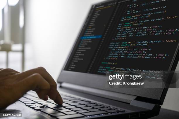 closeup computer code on screen, man programmer, software developer coding and programming on laptop. - codificar fotografías e imágenes de stock
