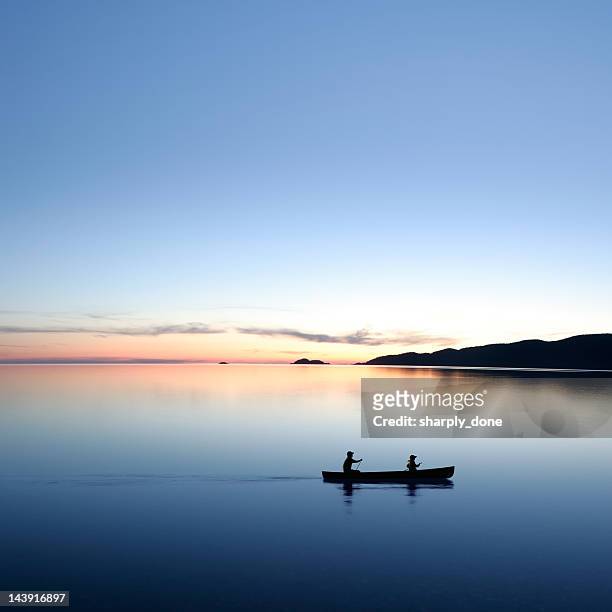 xxl twilight canoeing - two people canoeing on a lake stock pictures, royalty-free photos & images