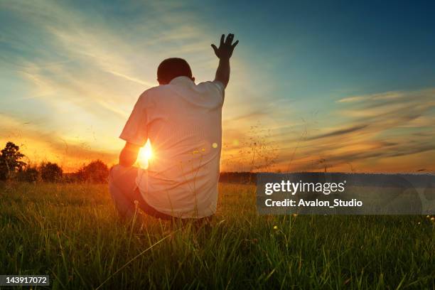 man prays to god - praying stock pictures, royalty-free photos & images
