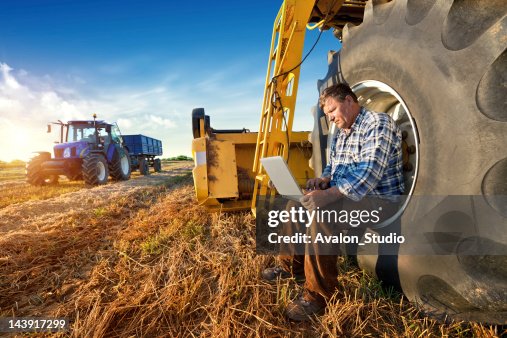 Farmer counts yields on a computer Farmer counts yields on a computer