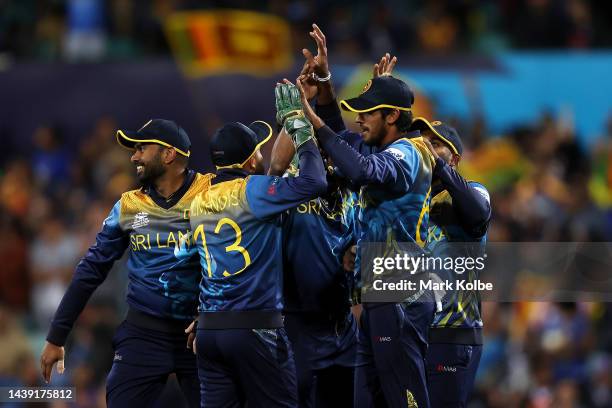 Kasun Rajitha of Sri Lanka celebrates with his team after taking the catch for the wicket of Sam Curran of England during the ICC Men's T20 World Cup...