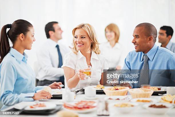 businesspeople having lunch indoors. - conference dining table stockfoto's en -beelden