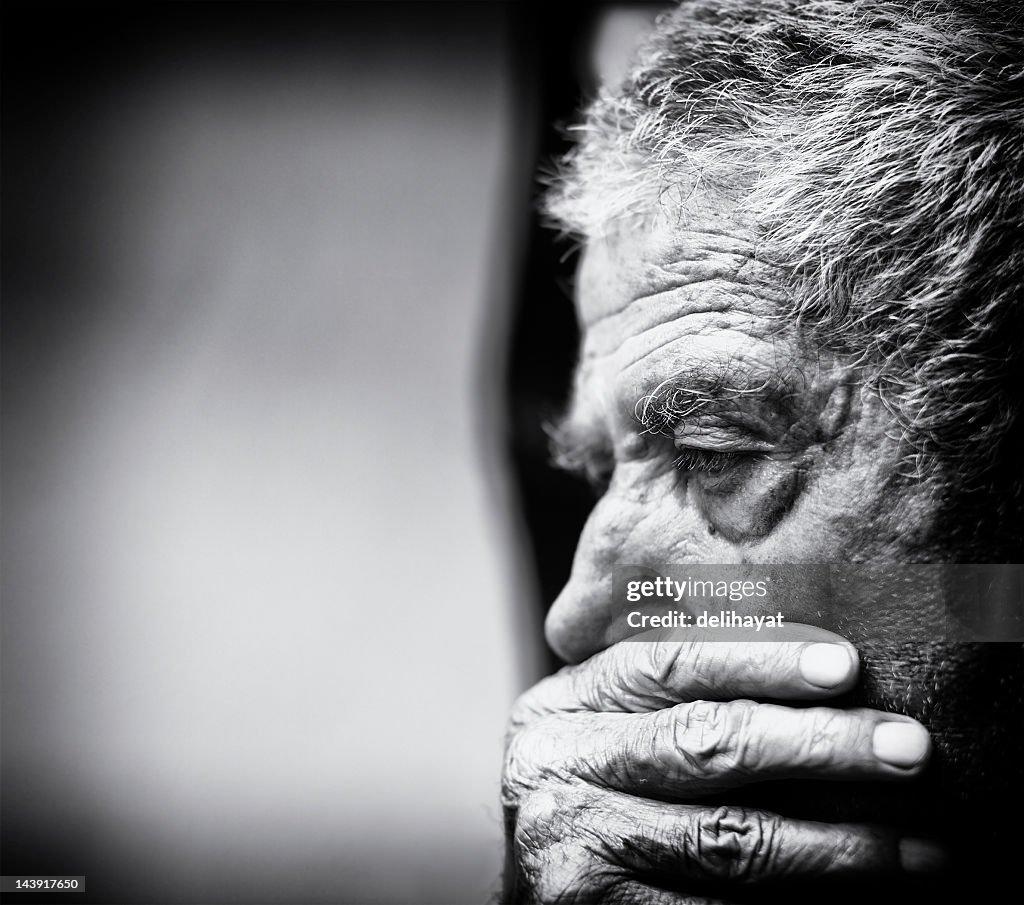 A black and white close-up of a senior man