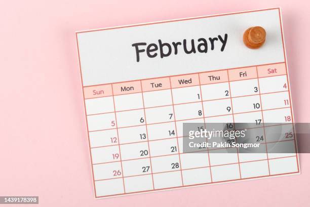 calendar desk 2023: february is the month for the organizer to plan and deadline with a push pin on paper background. - february stockfoto's en -beelden