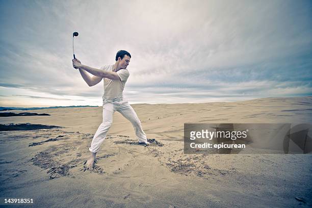 lone golfer in an infinite sand trap - bad golf swing stock pictures, royalty-free photos & images