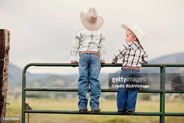 young cowboys - cowboy hat stock pictures, royalty-free photos & images