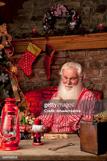 pictures of real santa claus in his workshop making toys - santas workshop stock pictures, royalty-free photos & images