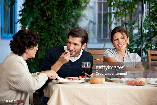family affairs - young couple and mother - mother in law stock pictures, royalty-free photos & images