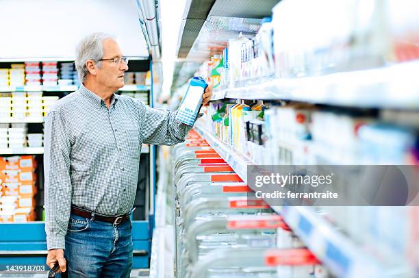 senior man shopping in supermarket - calcium stock pictures, royalty-free photos & images