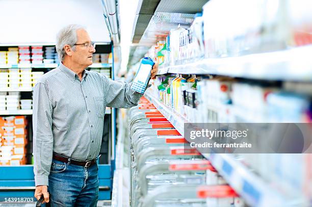 senior man shopping in supermarket - supermarket fridge stock pictures, royalty-free photos & images