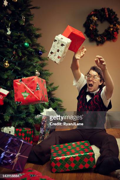christmas nerd child throws tantrum with gifts - furious stock pictures, royalty-free photos & images