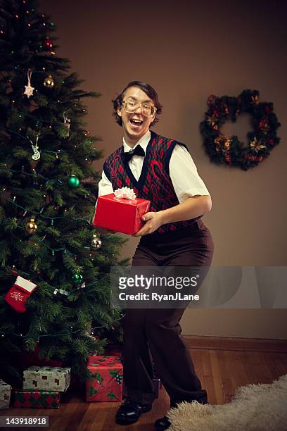 christmas nerd child giving gift - cheesy grin stock pictures, royalty-free photos & images