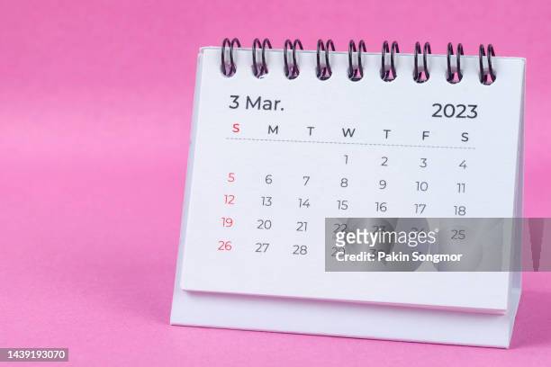 calendar desk 2023: march is the month for the organizer to plan and deadline with a pink paper background. - marzo fotografías e imágenes de stock