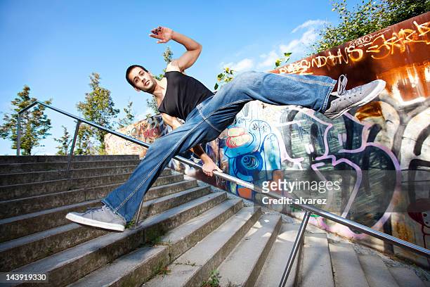 junger mann springt über die treppe - berlin graffiti stock-fotos und bilder