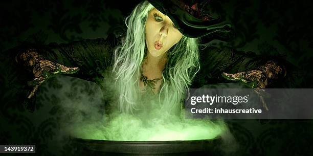 halloween witch conjuring a spell - cauldron stock pictures, royalty-free photos & images
