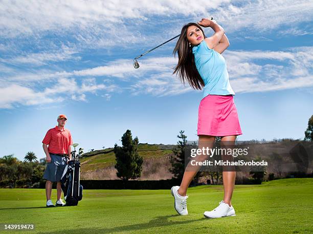 golfer and caddy - golf swing female stock pictures, royalty-free photos & images