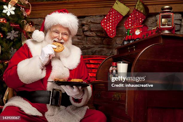 pictures of real santa claus enjoying milk and cookies - santa portrait stock pictures, royalty-free photos & images